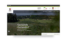 Alt-Text: Die Webseite der Gemeinde Gattendorf zeigt eine grüne Landschaft mit Hügeln und Bäumen im Hintergrund. Auf der Seite steht der Slogan "Gemeinsam erfolgreich leben.